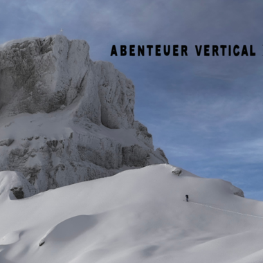 An impressive mountain landscape with snow-covered peaks and a clear sky. A person is exploring the alpine surroundings.